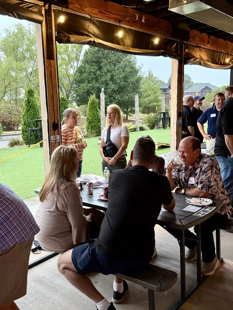 Attendees gathered at tables during the 2025 mixer